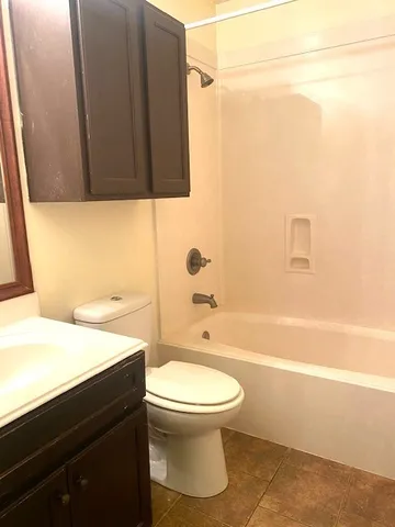 a bathroom with a toilet a sink and bathtub