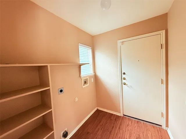 an empty room with windows and ceiling fan view