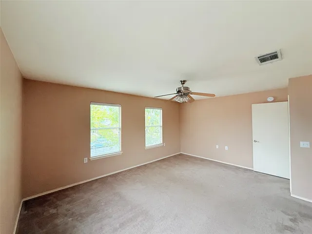 an empty room with windows and closet