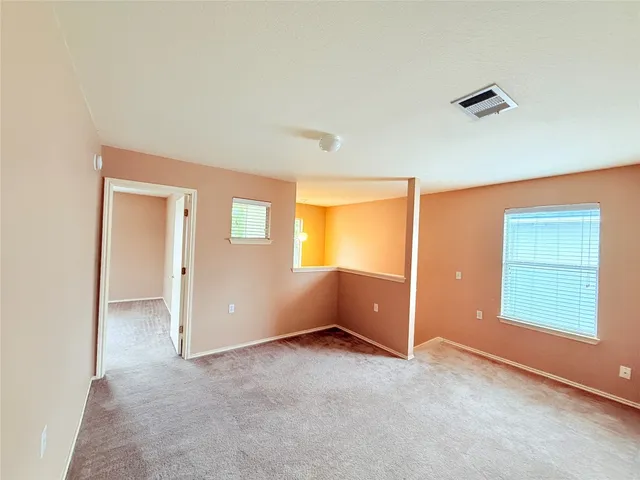 a front view of house with yard and trees in the background