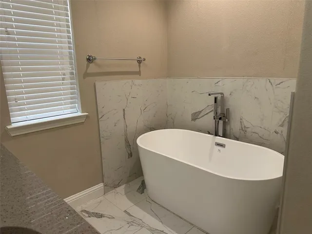 a white bath tub sitting in a bathroom