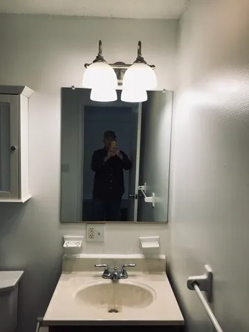 a bathroom with a sink and a mirror