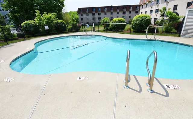 a view of swimming pool with a bench