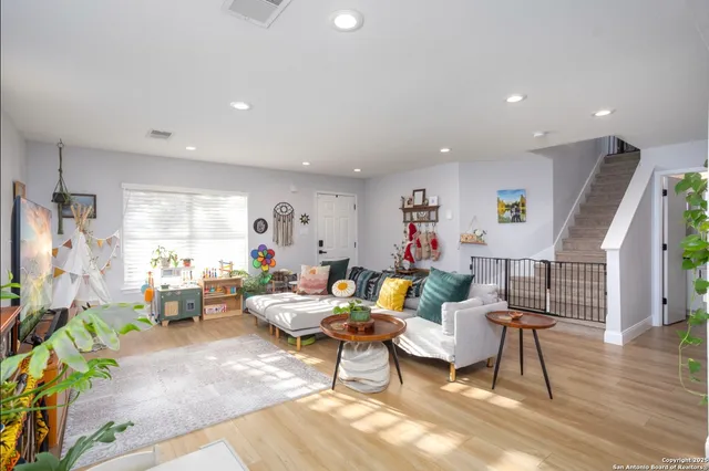 a living room with furniture and wooden floor