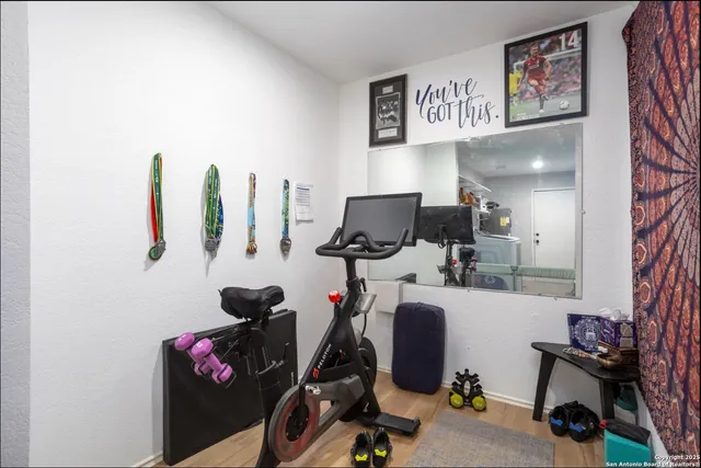 a view of a workspace with furniture and a window