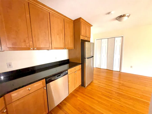 a kitchen with stainless steel appliances granite countertop a refrigerator and a stove