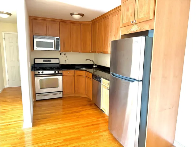 a kitchen with a refrigerator sink and stove