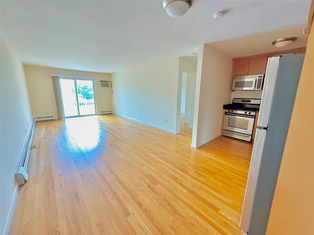 a view of a kitchen from a hallway