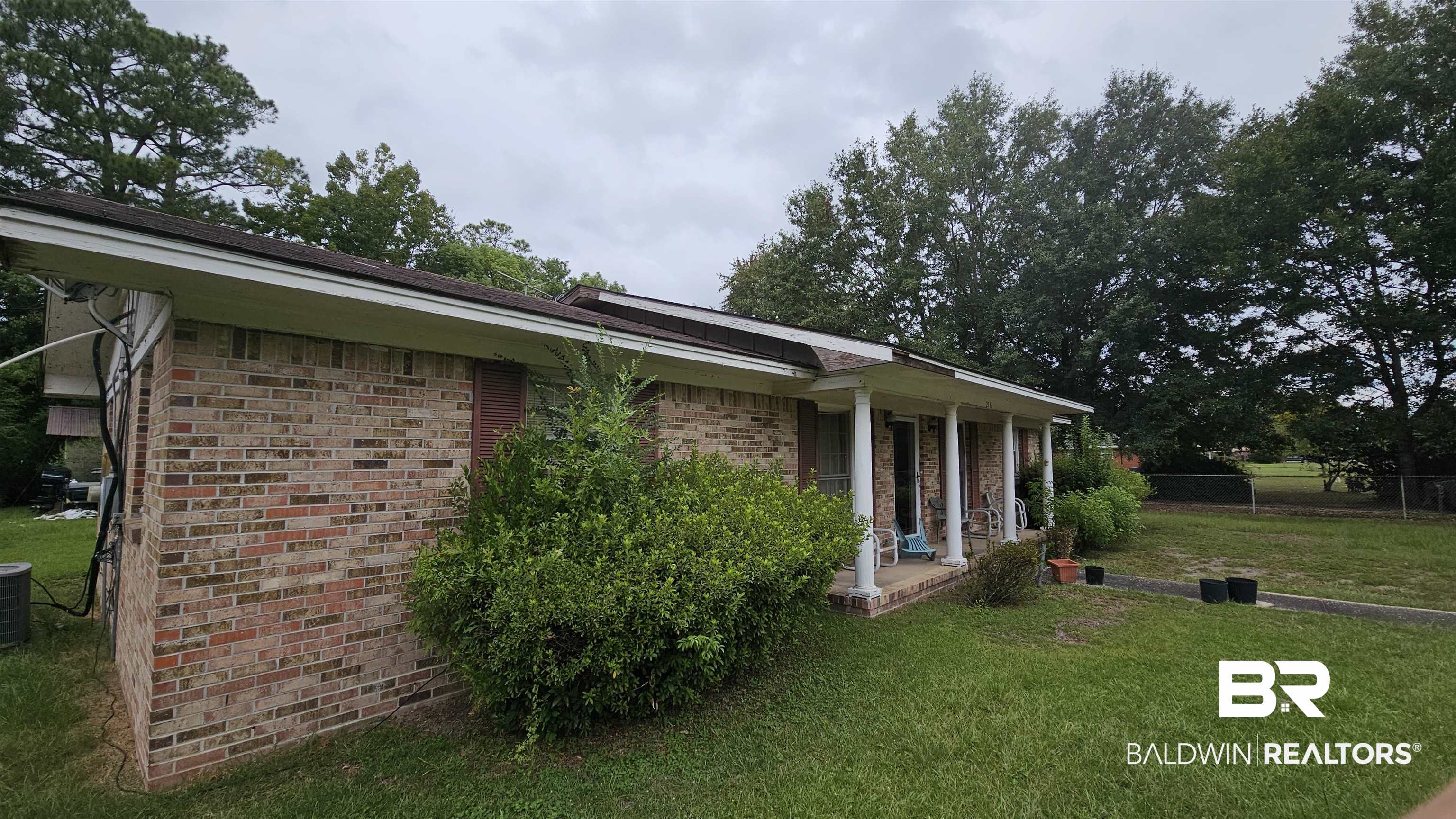 216 6th Avenue Atmore, AL 36502 - Photo 31 of 34 View of side of property with a porch and a yard