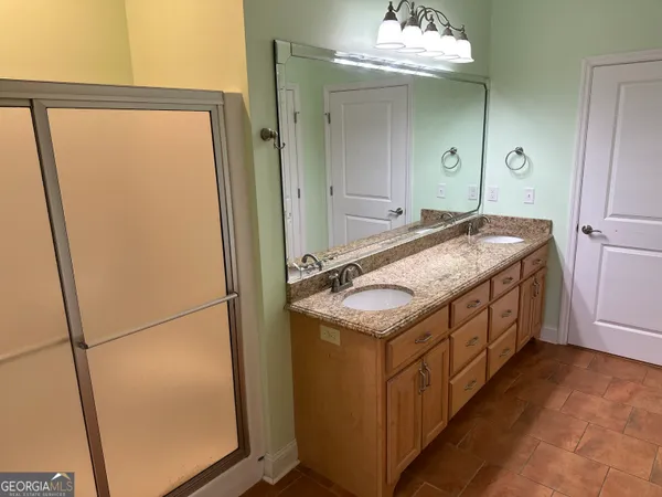 a kitchen with granite countertop cabinets stainless steel appliances and a sink