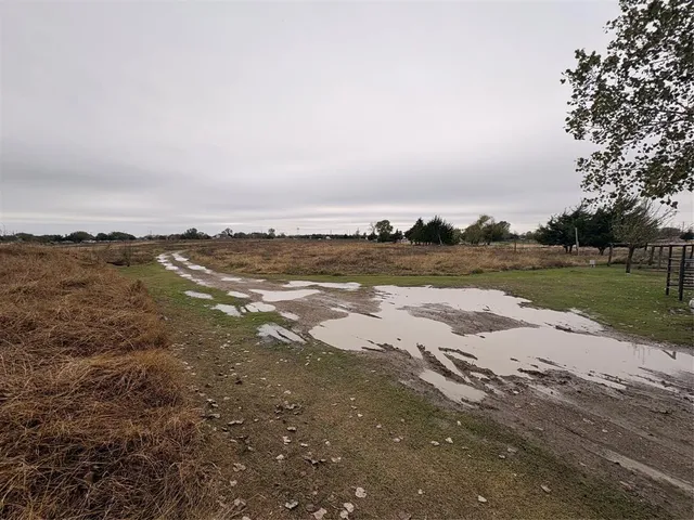 a view of a lake with sunset in background