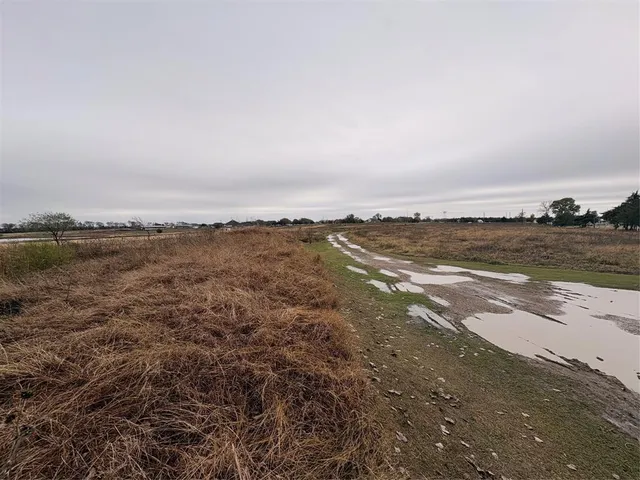 a view of a lake with houses in the back