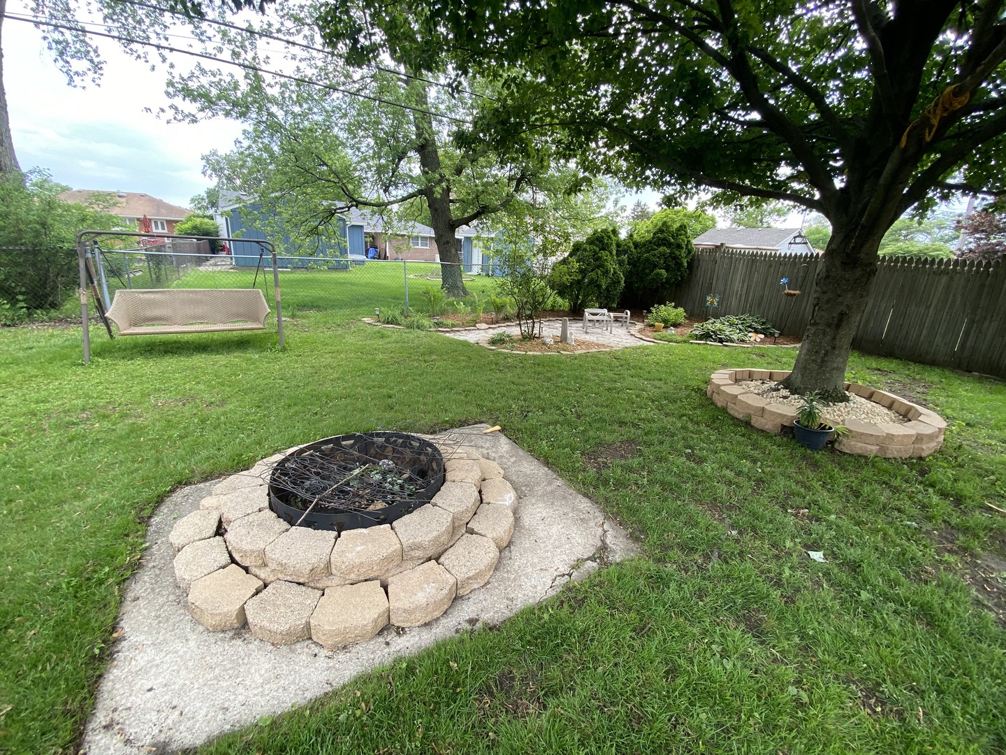 5831 109th Place Chicago Ridge, IL 60415 - Photo 17 of 19 a view of a backyard with table and chairs plants and large tree