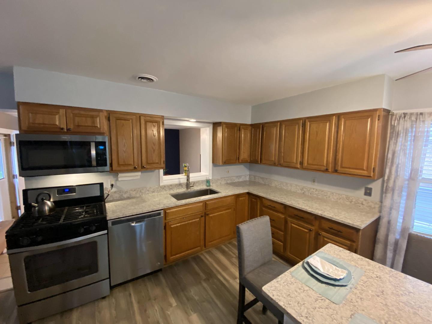 5831 109th Place Chicago Ridge, IL 60415 - Photo 5 of 19 a kitchen with a sink stove and cabinets