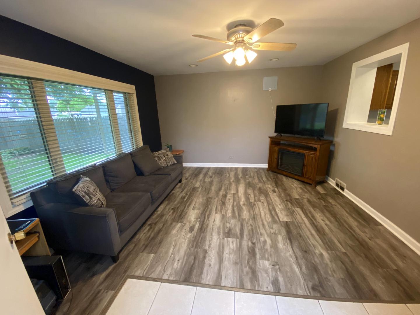 5831 109th Place Chicago Ridge, IL 60415 - Photo 8 of 19 a living room with furniture and a flat screen tv
