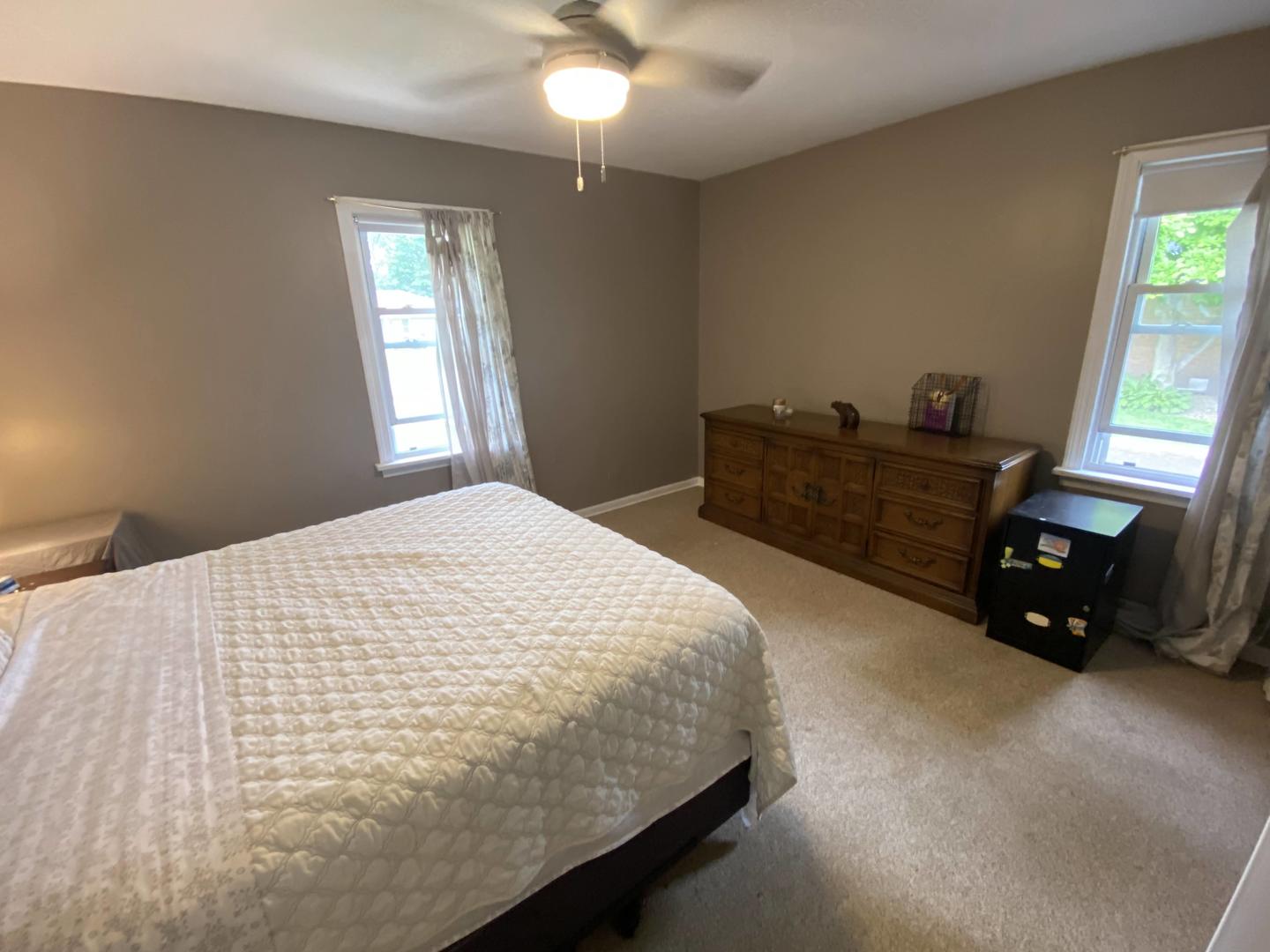 5831 109th Place Chicago Ridge, IL 60415 - Photo 10 of 19 a bed sitting in a bedroom next to a window