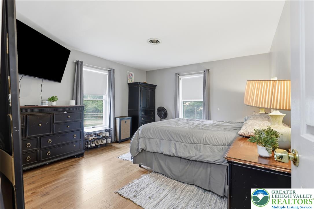 732 Bushkill Center Road Nazareth, PA 18064 - Photo 12 of 43 Hardwood floors and natural light define this cozy bedroom retreat.