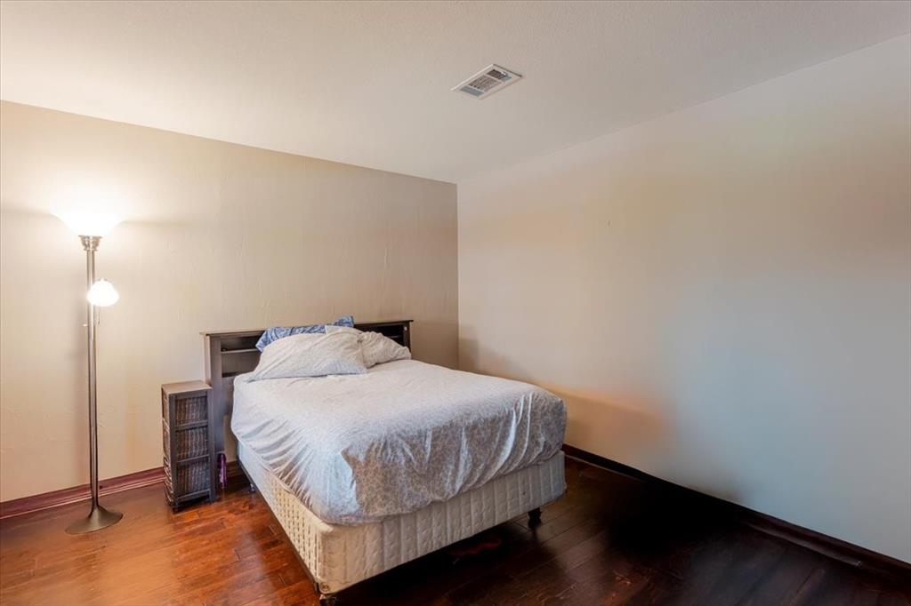 1507 Greenbrier Drive Sherman, TX 75092 - Photo 13 of 27 a bedroom with a bed and a night stand