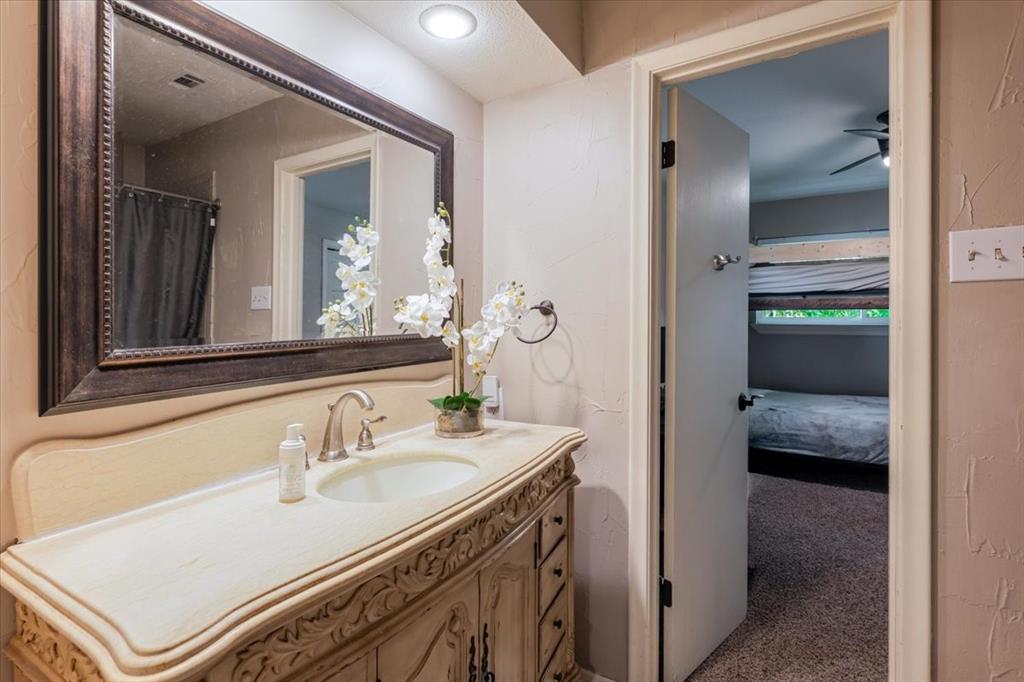 1507 Greenbrier Drive Sherman, TX 75092 - Photo 14 of 27 a en suite bathroom with a sink and a mirror