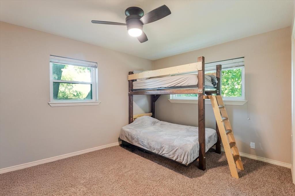 1507 Greenbrier Drive Sherman, TX 75092 - Photo 15 of 27 a bedroom with a bed and a chandelier