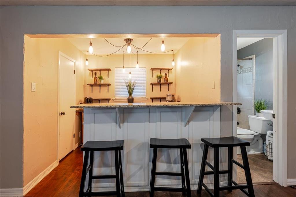 1507 Greenbrier Drive Sherman, TX 75092 - Photo 21 of 27 a kitchen with stainless steel appliances kitchen island a table and chairs in it