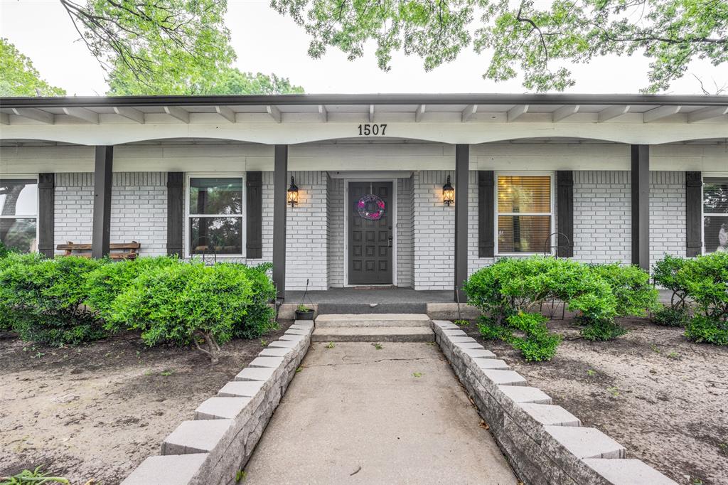 1507 Greenbrier Drive Sherman, TX 75092 - Photo 3 of 27 front view of a brick house with potted plants