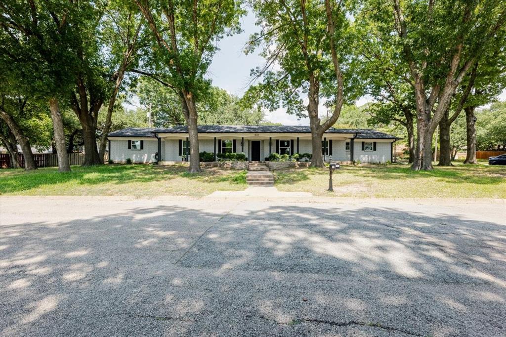 1507 Greenbrier Drive Sherman, TX 75092 - Photo 4 of 27 a front view of a house with swimming pool and a garden