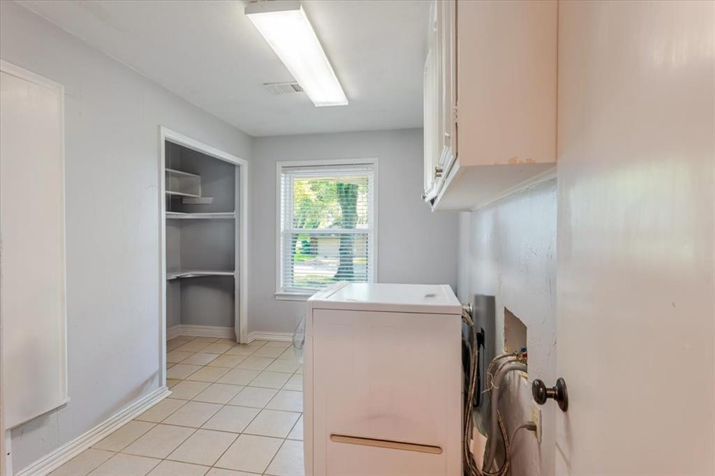 1507 Greenbrier Drive Sherman, TX 75092 - Photo 7 of 27 a utility room with cabinets washer and dryer