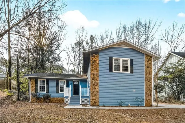 a front view of a house with a garden