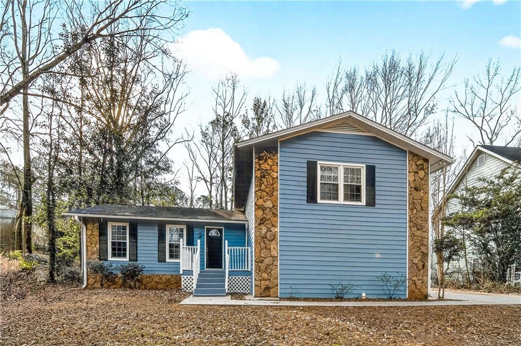 a front view of a house with a garden