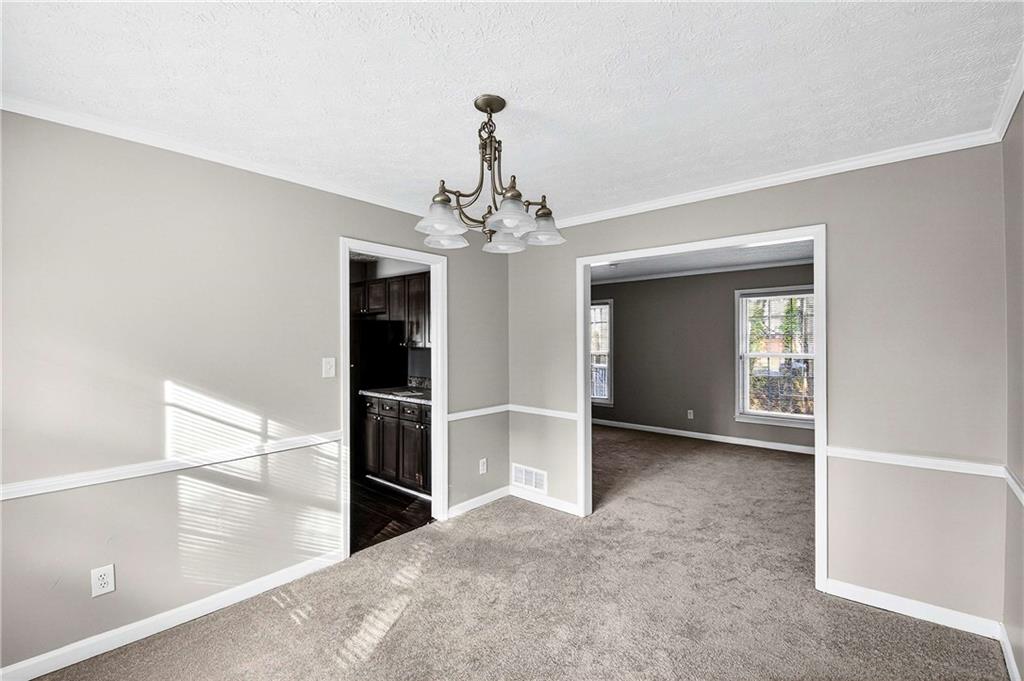 1075 Forest Heights Road Stone Mountain, GA 30083 - Photo 12 of 42 a view of a livingroom with a chandelier fan and windows