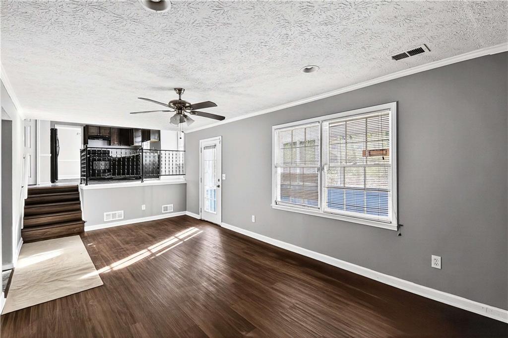 1075 Forest Heights Road Stone Mountain, GA 30083 - Photo 19 of 42 a view of a livingroom with wooden floor and furniture