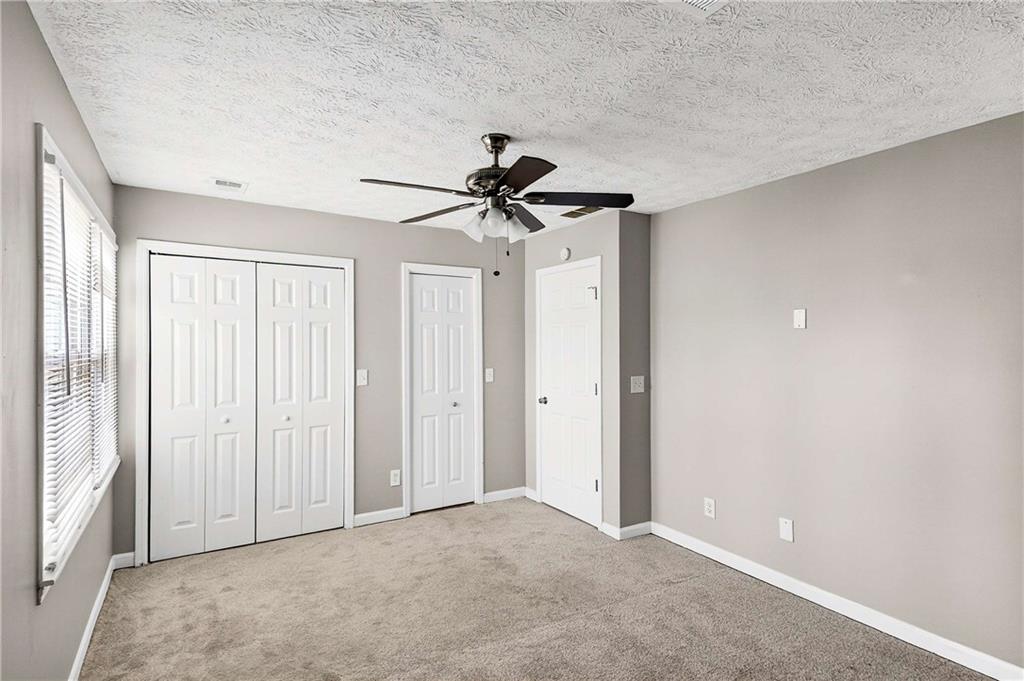 1075 Forest Heights Road Stone Mountain, GA 30083 - Photo 22 of 42 a view of a room with a ceiling fan