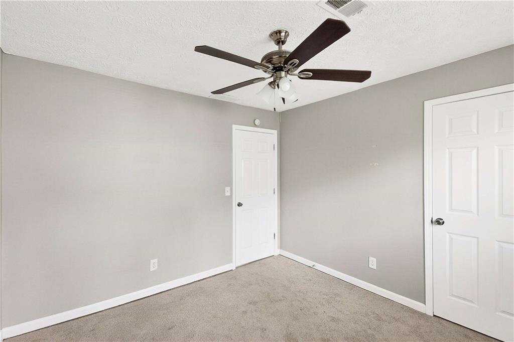 1075 Forest Heights Road Stone Mountain, GA 30083 - Photo 29 of 42 an empty room with a window and a fan