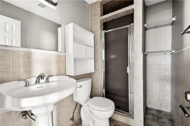 a bathroom with a sink toilet and shower