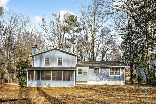 a front view of a house with a yard and lake view