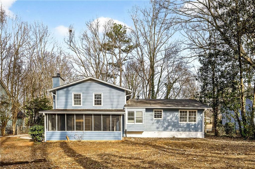1075 Forest Heights Road Stone Mountain, GA 30083 - Photo 35 of 42 a front view of a house with a yard and lake view