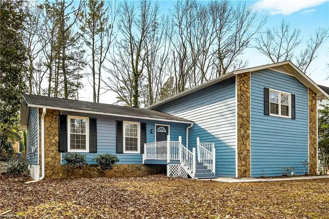 a front view of a house with a garden