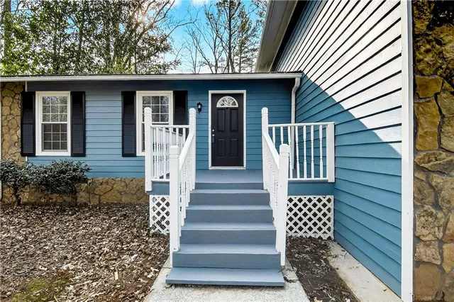 a front view of a house with a garden