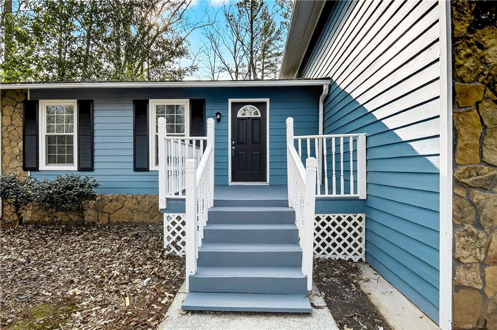 1075 Forest Heights Road Stone Mountain, GA 30083 - Photo 4 of 42 a front view of a house with a garden