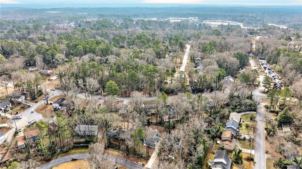 1075 Forest Heights Road Stone Mountain, GA 30083 - Photo 41 of 42 an aerial view of residential house with parking and yard