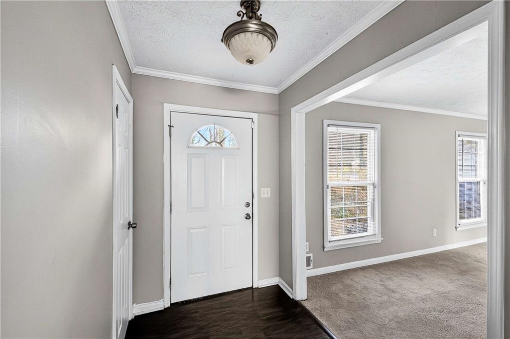 1075 Forest Heights Road Stone Mountain, GA 30083 - Photo 6 of 42 a view of an empty room with wooden floor and a window
