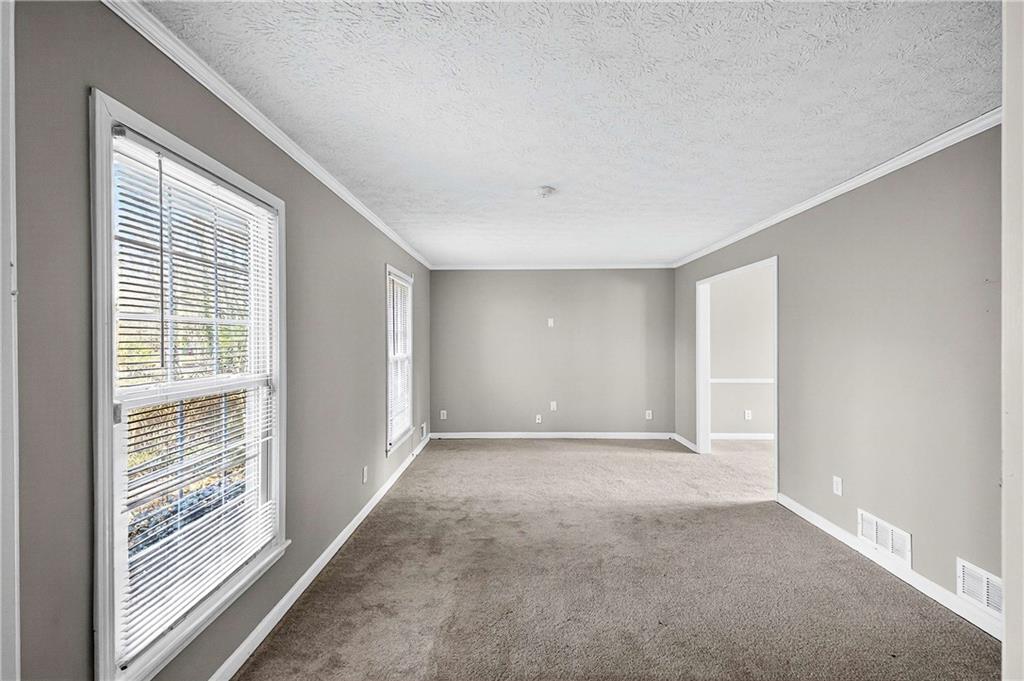 1075 Forest Heights Road Stone Mountain, GA 30083 - Photo 7 of 42 a view of an empty room with a window