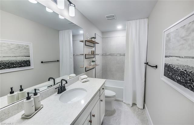 3974 East Hampton Circle Fort Myers, FL 33905 - Photo 11 of 36 a bathroom with a sink toilet vanity and shower