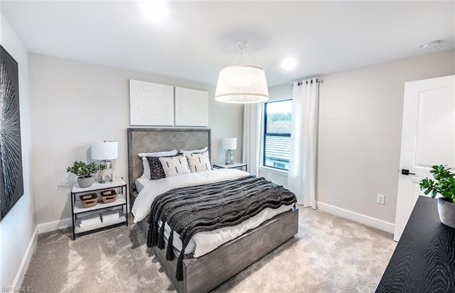 3974 East Hampton Circle Fort Myers, FL 33905 - Photo 12 of 36 a bedroom with a bed and a potted plant