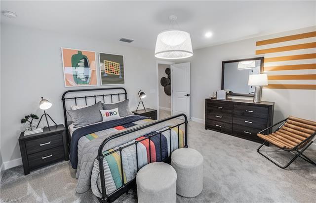3974 East Hampton Circle Fort Myers, FL 33905 - Photo 14 of 36 a bedroom with a bed and a chandelier
