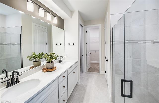 3974 East Hampton Circle Fort Myers, FL 33905 - Photo 24 of 36 a bathroom with a sink a potted plant and a mirror