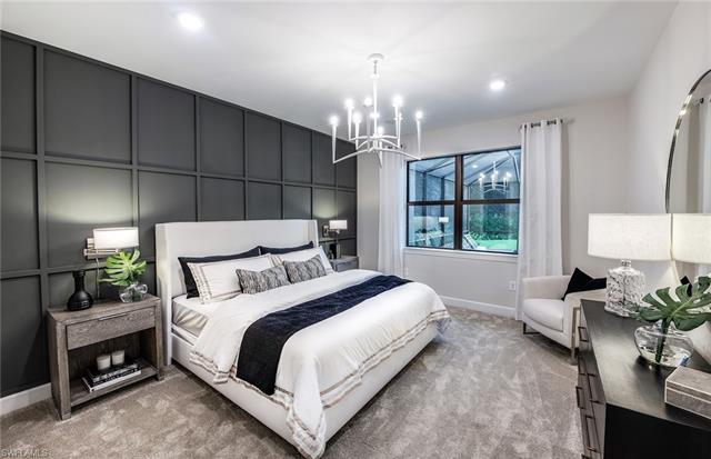 3974 East Hampton Circle Fort Myers, FL 33905 - Photo 25 of 36 a bedroom with a bed potted plant on dresser and a chandelier