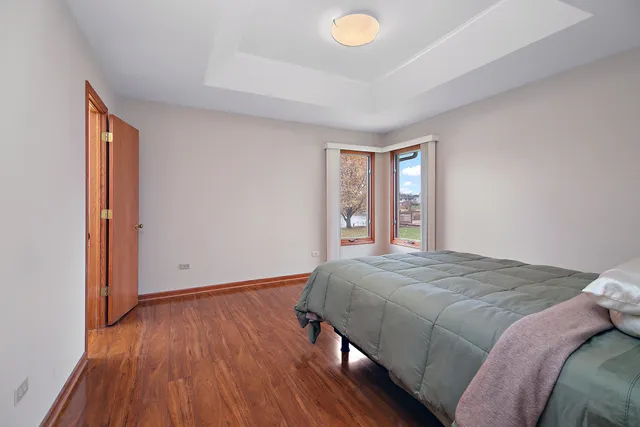 a bathroom with a granite countertop toilet a sink and a mirror