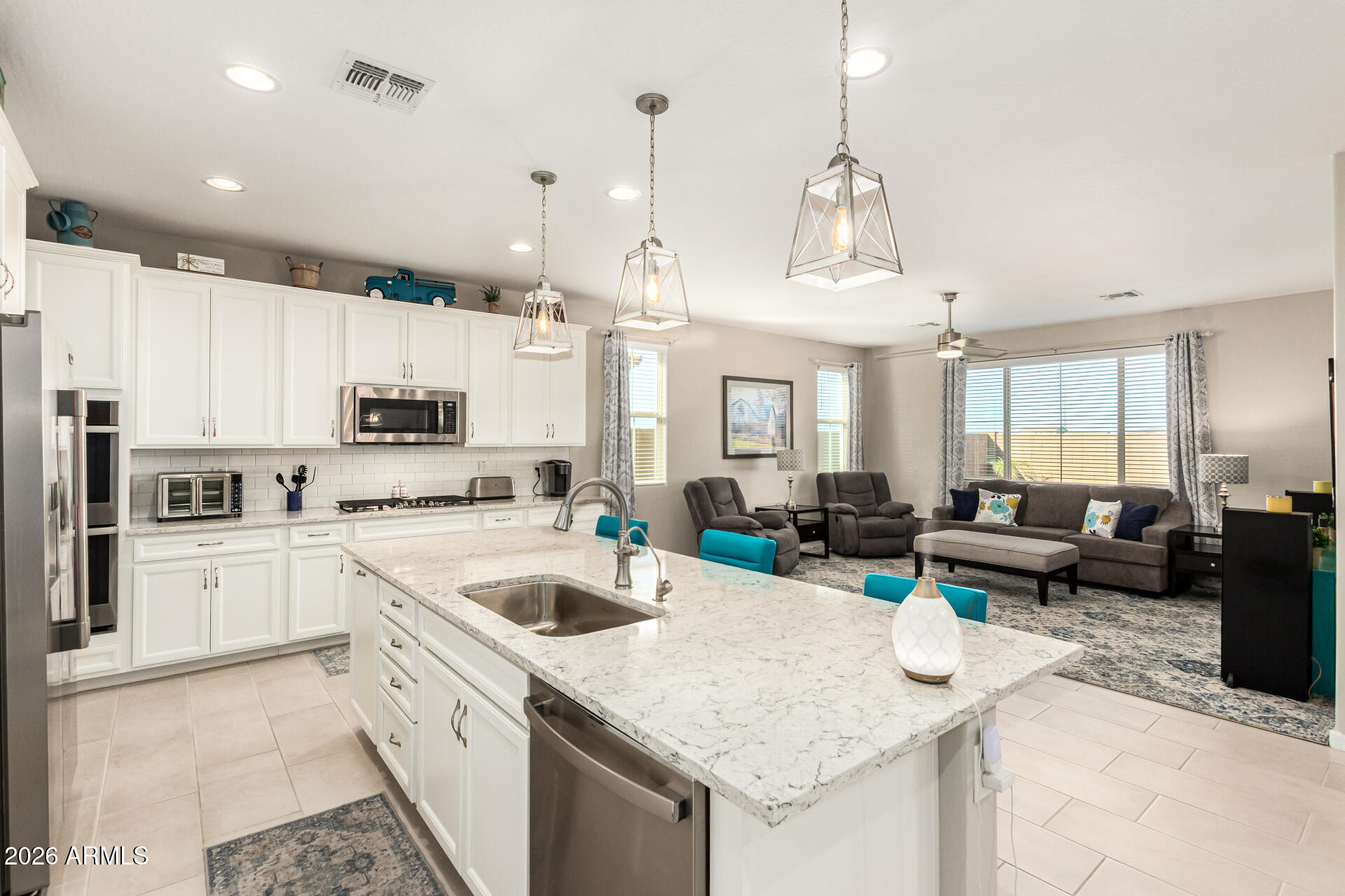22494 East Russet Road Queen Creek, AZ 85142 - Photo 16 of 43 a kitchen that has a lot of white cabinets and stainless steel appliances